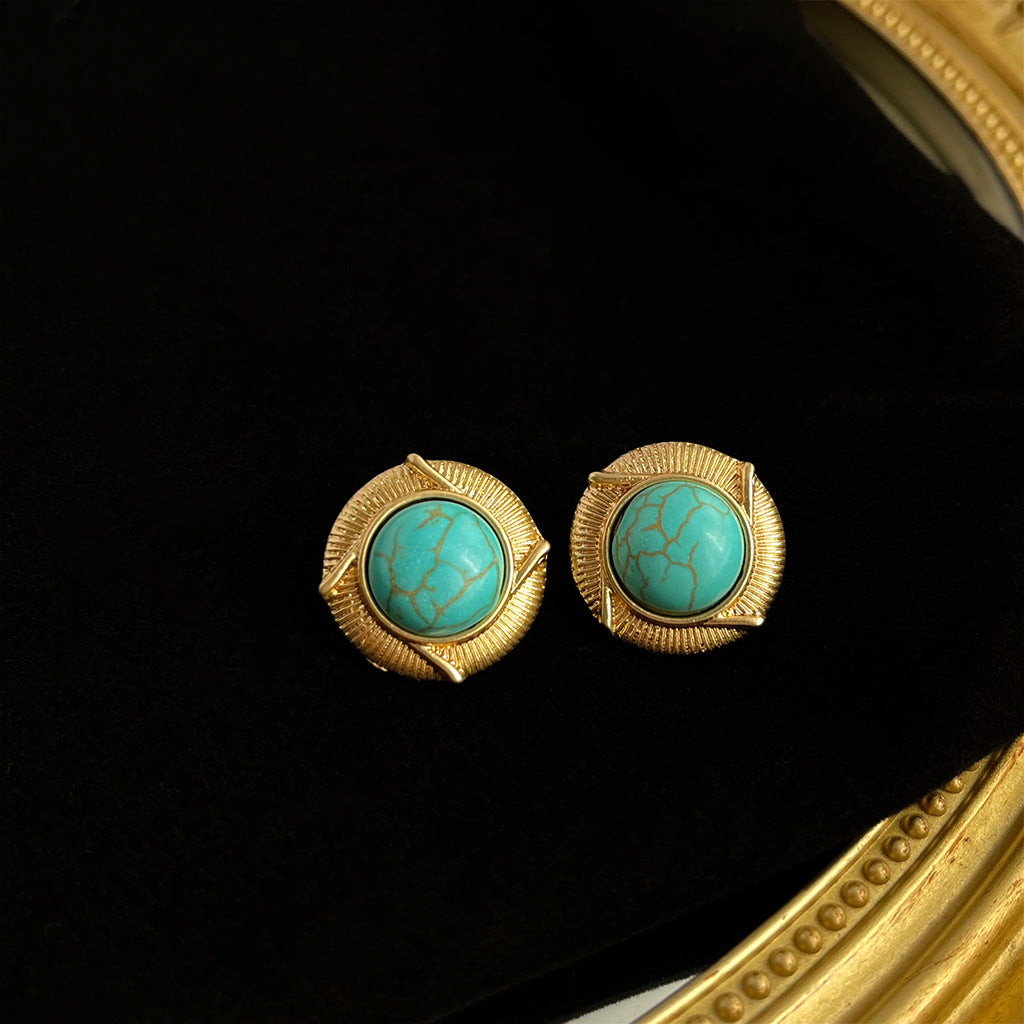 Vintage turquoise earrings featuring a geometric design with electroplated metal studs, embodying retro elegance and artisanal craftsmanship.