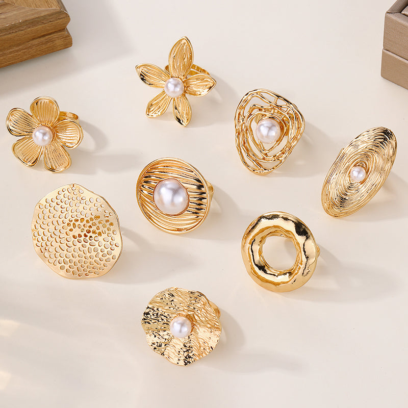 Gold pearl ring with different shapes and designs.