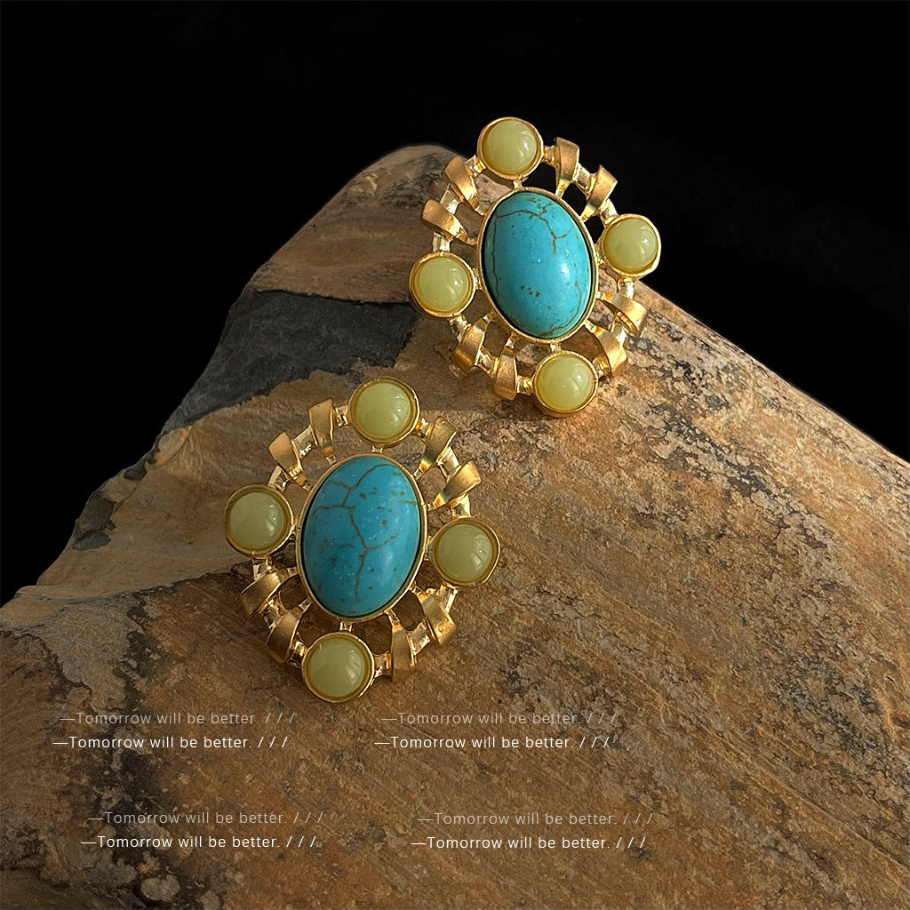 Artistic vintage turquoise earrings with silver needle posts and geometric patterns, showcasing heavy craftsmanship and retro luxury.