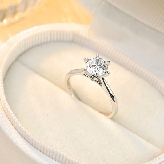 A minimalist classic 6-prong lab-grown round diamond engagement ring with a hidden halo