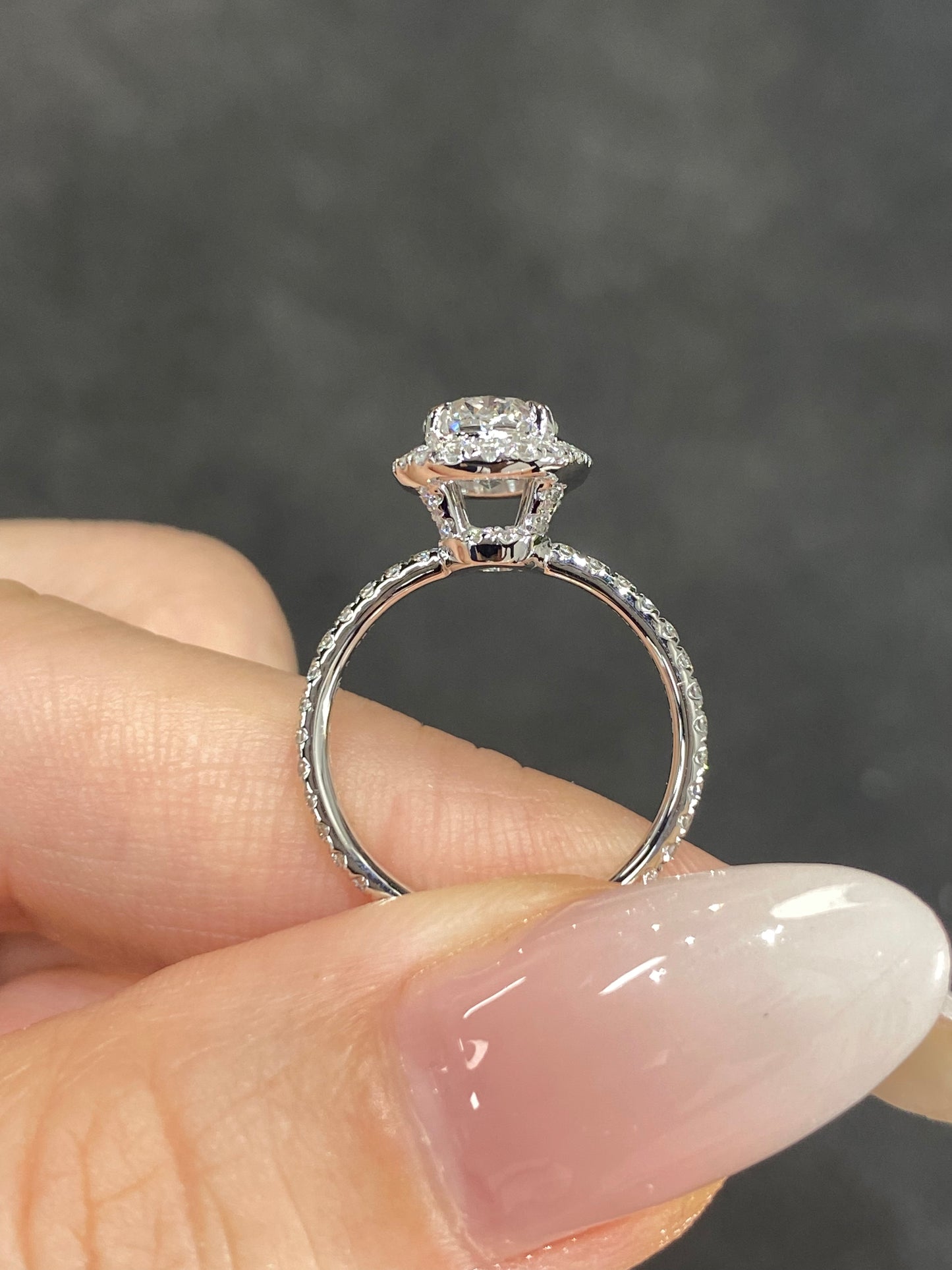 Oval Halo Lab Grown Diamond Engagement Ring in 18K White Gold, featuring a brilliant oval diamond surrounded by a halo with pave setting.