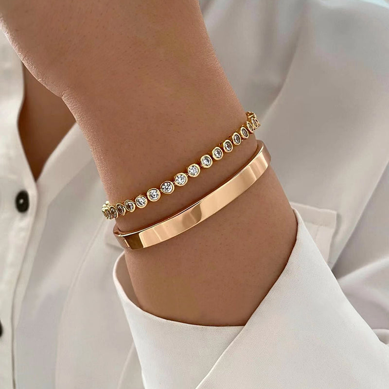 Vintage gold-tone bracelet set for women featuring a geometric bangle with a smooth finish and a waterdrop-shaped cuff with cubic zirconia accents, crafted from zinc alloy with electroplating.